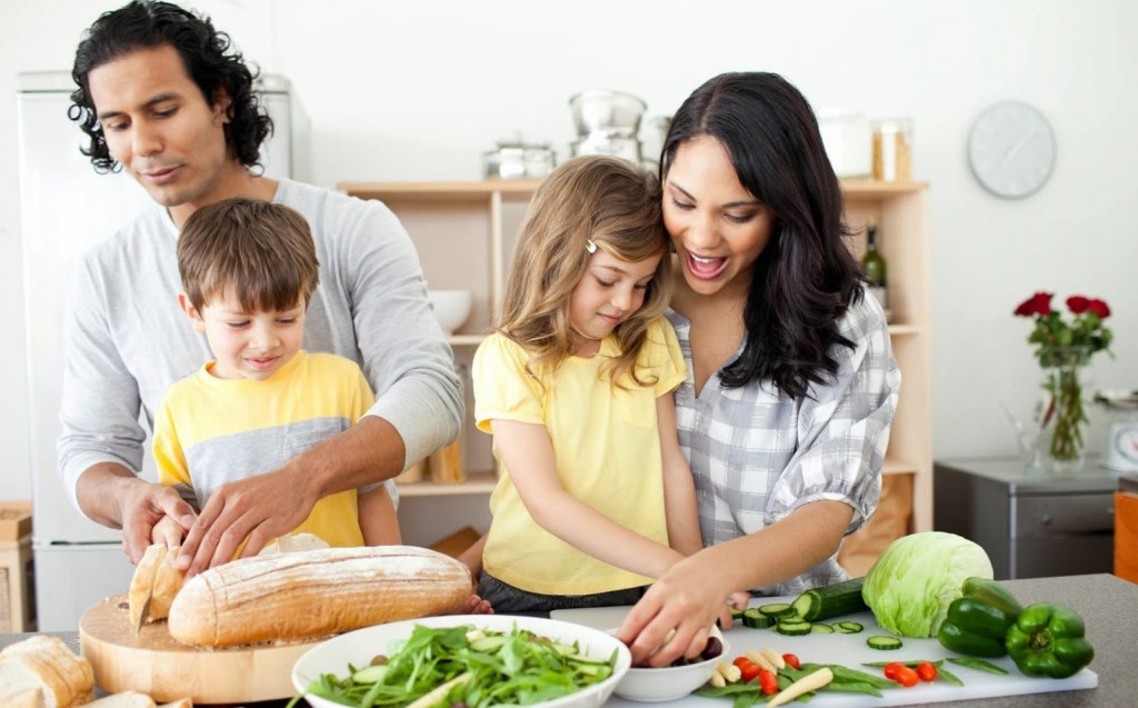 Positive family preparing lunch together